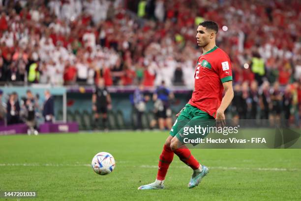 Achraf Hakimi of Morocco scores the team's fourth and winning penalty in the penalty shoot out during the FIFA World Cup Qatar 2022 Round of 16 match...