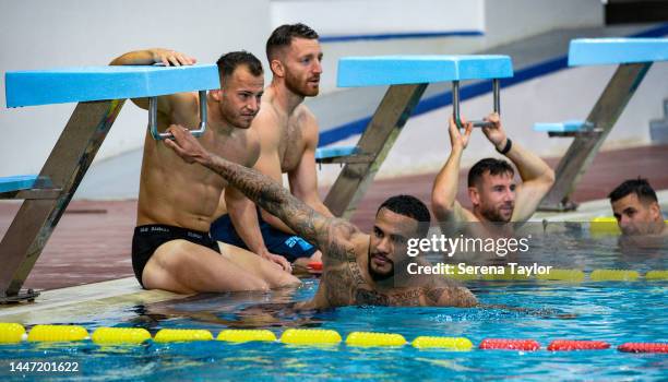 Jamaal Lascelles holds on to the bar of a diving block during the Newcastle United Training Session at the Al Hilal FC Training Centre on December...