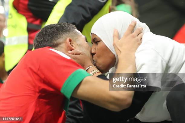 Achraf Hakimi of Morocco kisses a lady in the stands following the penalty shoot out victory in the FIFA World Cup Qatar 2022 Round of 16 match...