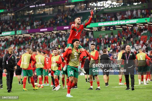 Hakim Ziyech and Zakaria Aboukhlal of Morocco celebrate after their victory through the penalty shootout during the FIFA World Cup Qatar 2022 Round...