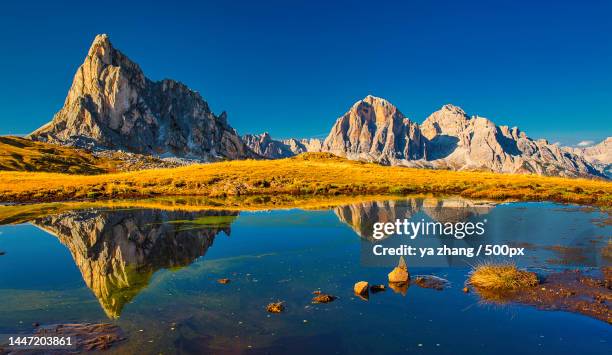 scenic view of lake and mountains against clear blue sky,passo di giau,colle santa lucia,belluno,italy - colle santa lucia stock pictures, royalty-free photos & images