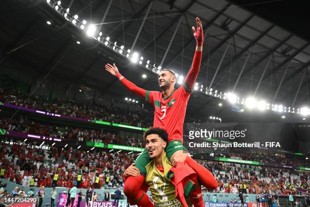 Hakim Ziyech and Zakaria Aboukhlal of Morocco celebrate after their victory through the penalty shootout during the FIFA World Cup Qatar 2022 Round...