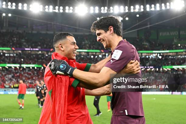 Yassine Bounou of Morocco celebrates with teammates after their win in the penalty shoot out during the FIFA World Cup Qatar 2022 Round of 16 match...