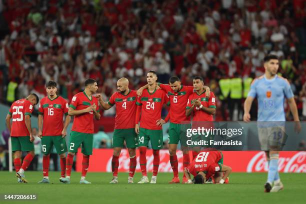 Morocco players react as Carlos Soler of Spain makes his way forward to take a penalty during the shoot out in the FIFA World Cup Qatar 2022 Round of...