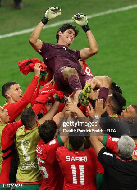 Yassine Bounou of Morocco celebrates with teammates after the penalty shootout win during the FIFA World Cup Qatar 2022 Round of 16 match between...