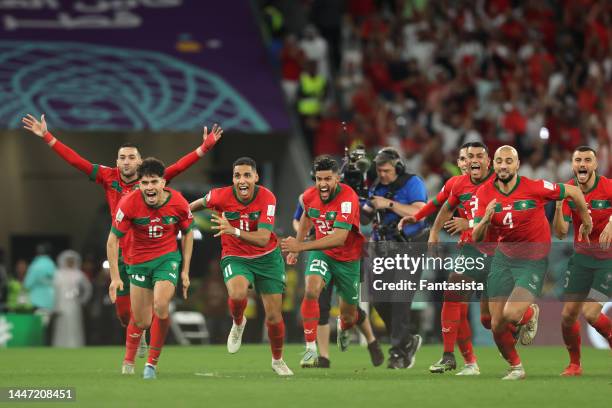 Morocco players celebrate after Achraf Hakimi scorted the decisive spot kick during the penalty shoot out in the FIFA World Cup Qatar 2022 Round of...