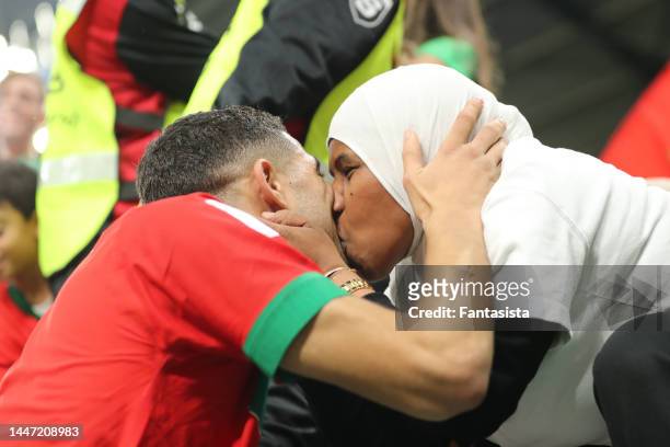 Achraf Hakimi of Morocco kisses a lady in the stands following the penalty shoot out victory in the FIFA World Cup Qatar 2022 Round of 16 match...