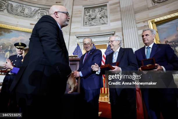 Senate Minority Leader Mitch McConnell holds out his hand for a handshake with Kenneth Sicknick , the brother of Capitol Police officer Brian...