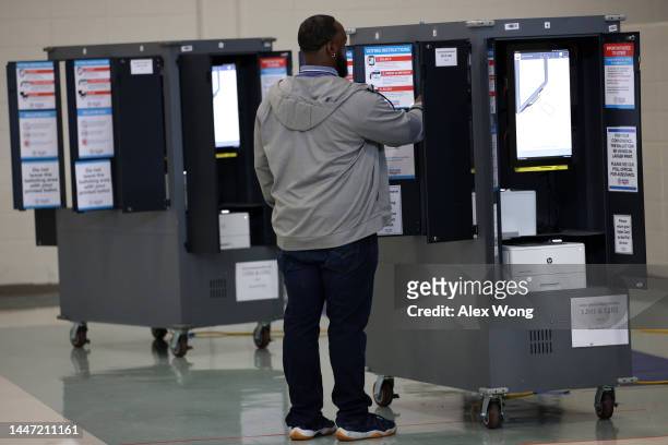 Voter casts his ballot at a polling station for the U.S. Senate runoff election on December 6, 2022 in Atlanta, Georgia. Georgians head to the polls...