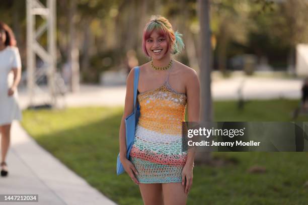 Guest seen wearing a colourful mini dress and flat shoes on December 03, 2022 in Miami, Florida.