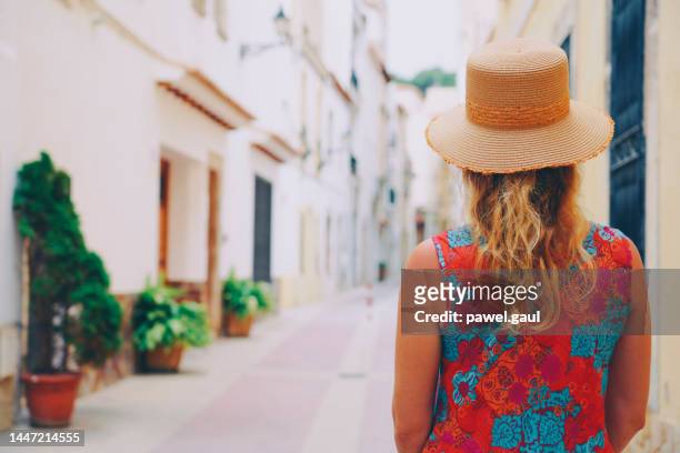 woman walking down the streets of tossa de mar costa brava catalonia spain - tossa de mar bildbanksfoton och bilder
