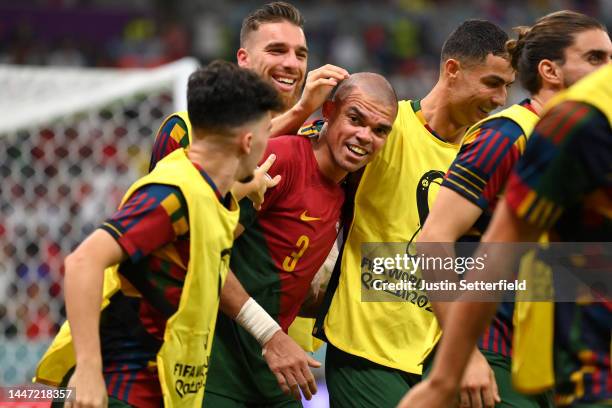 Pepe of Portugal celebrates with Cristiano Ronaldo and teammates after scoring the team's second goal during the FIFA World Cup Qatar 2022 Round of...