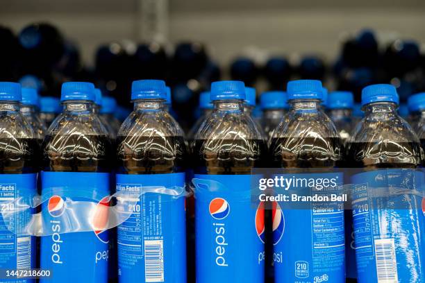 Pepsi sodas displayed on shelves at a Walmart Supercenter on December 06, 2022 in Austin, Texas. PepsiCo, the maker of Pepsi soda, plans to cut...