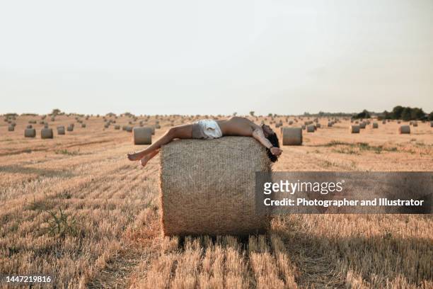 young man lies on a haystack - bal odlad bildbanksfoton och bilder