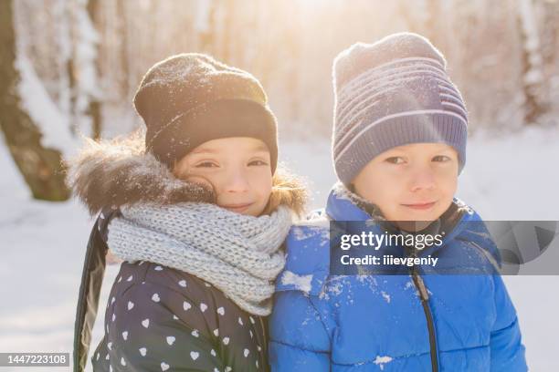 girl and boy portrait in jacket and hat in winter forest. children. happy childhood. winter holiday. deep snow. warm clothes - girl white background stock pictures, royalty-free photos & images