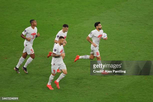 Manuel Akanji of Switzerland celebrates with teammates after scoring the team's first goal during the FIFA World Cup Qatar 2022 Round of 16 match...