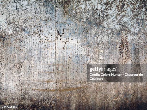 weathered white and blue paintings on a rusty and textured metal plate in paris - patina stock pictures, royalty-free photos & images