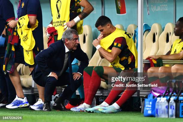 Fernando Santos, Head Coach of Portugal, speaks with Cristiano Ronaldo before a substitution during the FIFA World Cup Qatar 2022 Round of 16 match...