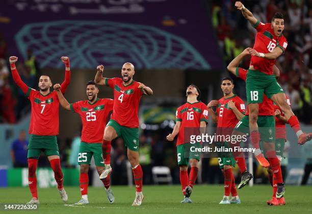 Morocco players celebrate after their win in the penalty shoot out during the FIFA World Cup Qatar 2022 Round of 16 match between Morocco and Spain...