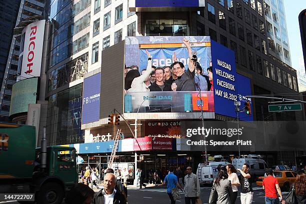 Facebook founder Mark Zuckerberg is seen on a screen in Times Square moments after he rang the Opening Bell for the Nasdaq stock market board from...