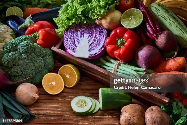 assorted fresh vegetables and fruits in wooden crate. - cassetta foto e immagini stock