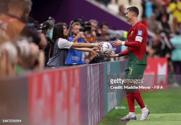 Cristiano Ronaldo of Portugal is passed the ball by a ball kid during the FIFA World Cup Qatar 2022 Round of 16 match between Portugal and...