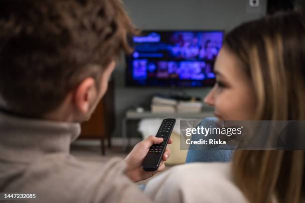 couple in love spending their leisure time together - changing channels stockfoto's en -beelden