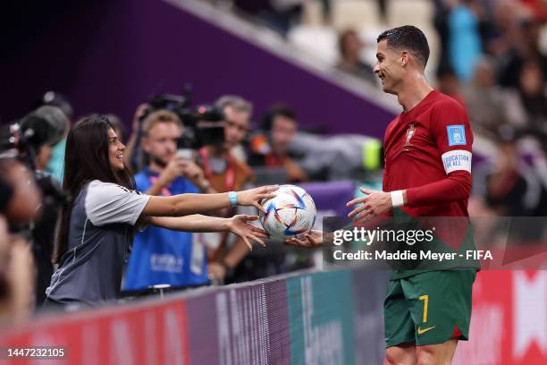 Cristiano Ronaldo of Portugal passes the match ball to a ball kid during the FIFA World Cup Qatar 2022 Round of 16 match between Portugal and...