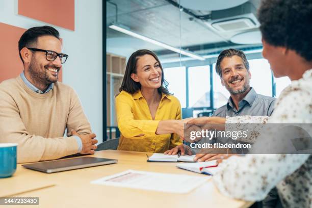 handshake for successful partnership - staff meeting stock pictures, royalty-free photos & images