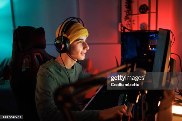teenage gaming streamer playing video game in his room - gamer stock pictures, royalty-free photos & images