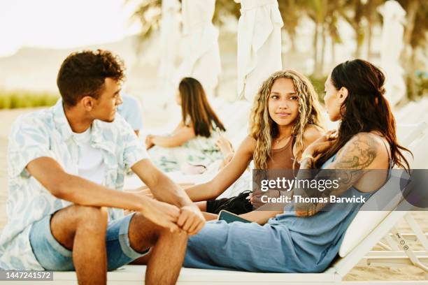 medium shot of mother hanging out with children during vacation - teen boy shorts stock pictures, royalty-free photos & images