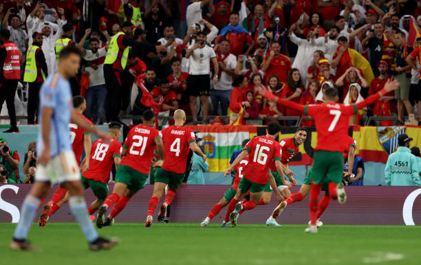 Achraf Hakimi of Morocco celebrates with his team mates after scoring the winning penalty in the shoot out after extra time during the FIFA World Cup...