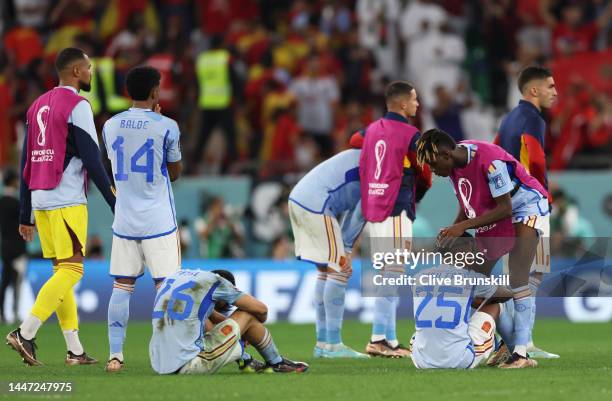 Ansu Fati of Spain consoled by team mate Nico Williams of Spain after their team lost the penalty shoot out during the FIFA World Cup Qatar 2022...