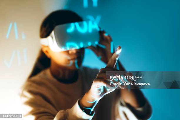 modern african american woman is using vr glasses to access metaverse world - draft media availability foto e immagini stock