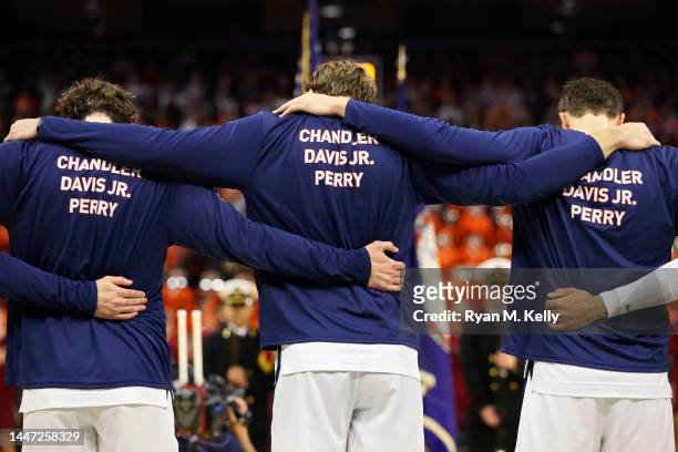 Virginia Cavaliers basketball players wear warmup shirts honoring slain football players Devin Chandler, Lavel Davis Jr. And D'Sean Perry before the...