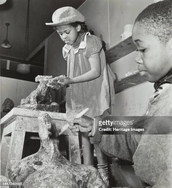Girl and boy sculpting, Harlem Art Center, 1939. Creator: Berenice Abbott.