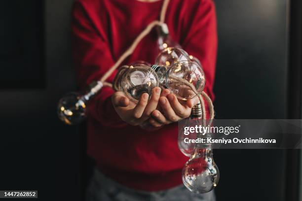 hands holding fairy lights with focus on lights. - orlando background stock pictures, royalty-free photos & images