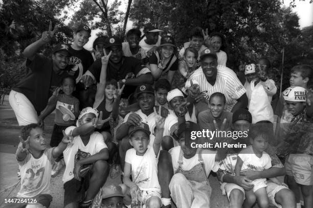 Rapper Chuck D of Public Enemy, Charles Oakley of the New York Knicks and Rick Mahorn of the New Jersey Nets visit a park in Jersey City to meet with...