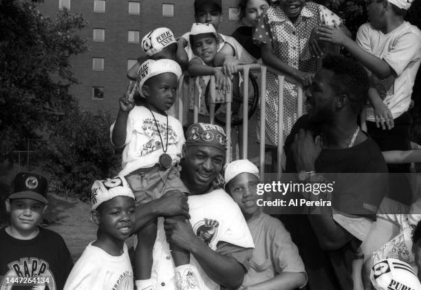 Rapper Chuck D of Public Enemy and Charles Oakley of the New York Knicks visit a park in Jersey City to meet with children and donate a van full of...