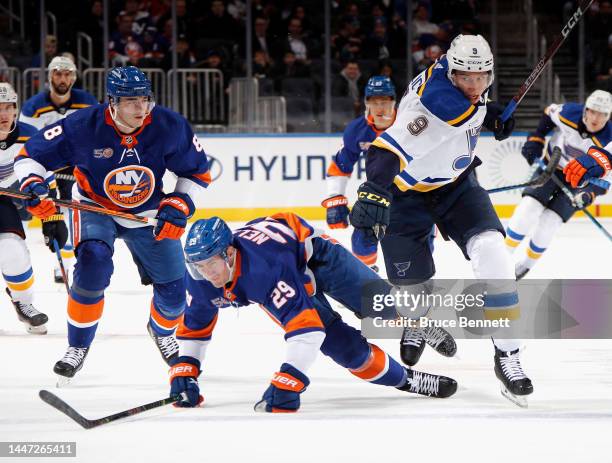 Tyler Pitlick of the St. Louis Blues pushes his way past Brock Nelson of the New York Islanders during the first period at the UBS Arena on December...