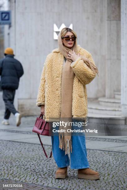 Victoria Scheu wears wide leg denim jeans Baum & Pferdgarten, Ugg Plateau boots, mustard shearling coat Stand Studio, burgundy Boyy bag, NAKD scarf...