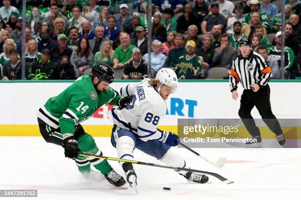 William Nylander of the Toronto Maple Leafs controls the puck against Jamie Benn of the Dallas Stars in the second period at American Airlines Center...
