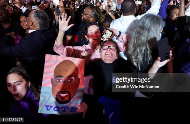 Supporters cheer as the Georgia runoff election is called for Sen. Raphael Warnock at the Warnock election night watch party at the Marriott Marquis...