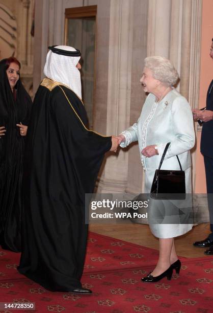 King of Bahrain Hamad ibn Isa Al Khalifa is greeted by Queen Elizabeth II as he arrives at a lunch for Sovereign Monarch's held in honour of Queen...