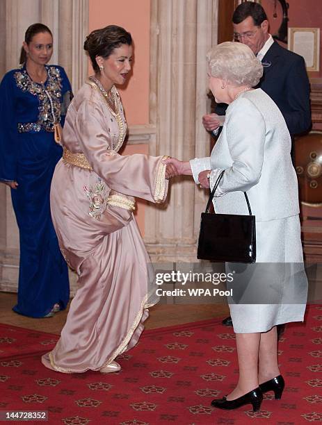 Princess Lalla Meryem of Morocco is greeted by Queen Elizabeth II as he arrives at a lunch for Sovereign Monarch's held in honour of Queen Elizabeth...