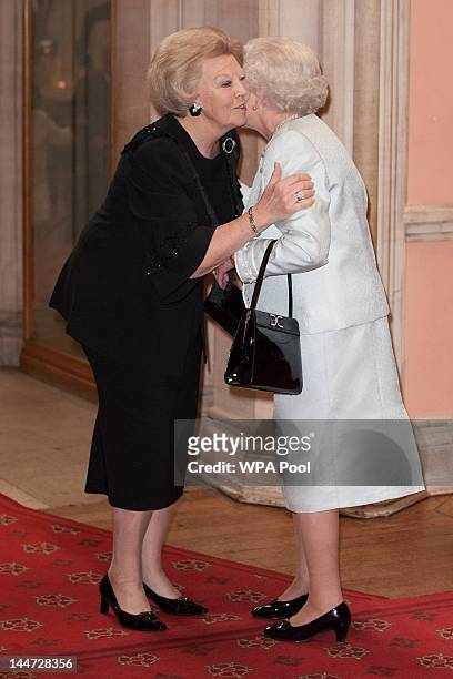 Beatrix, Queen of the Netherlands is greeted by Queen Elizabeth II as he arrives at a lunch for Sovereign Monarch's held in honour of Queen Elizabeth...