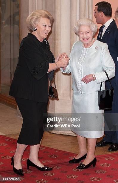 Beatrix; Queen of the Netherlands is greeted by Queen Elizabeth II as he arrives at a lunch for Sovereign Monarch's held in honour of Queen Elizabeth...