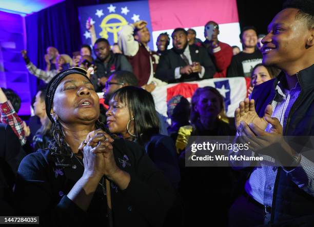 Supporters cheer as the Georgia Senate runoff election is called for Sen. Raphael Warnock at the Warnock election night watch party at the Marriott...