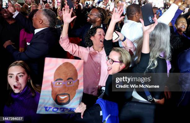 Supporters cheer as the Georgia Senate runoff election is called for Sen. Raphael Warnock at the Warnock election night watch party at the Marriott...