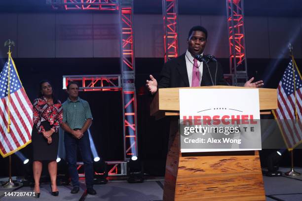 Georgia Republican Senate candidate Herschel Walker delivers his concession speech as his wife Julie Blanchard and former football player Doug Flutie...